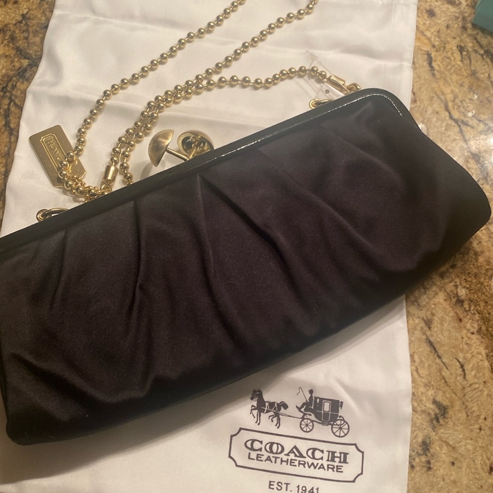 Coach black evening hand bag with removable strap.